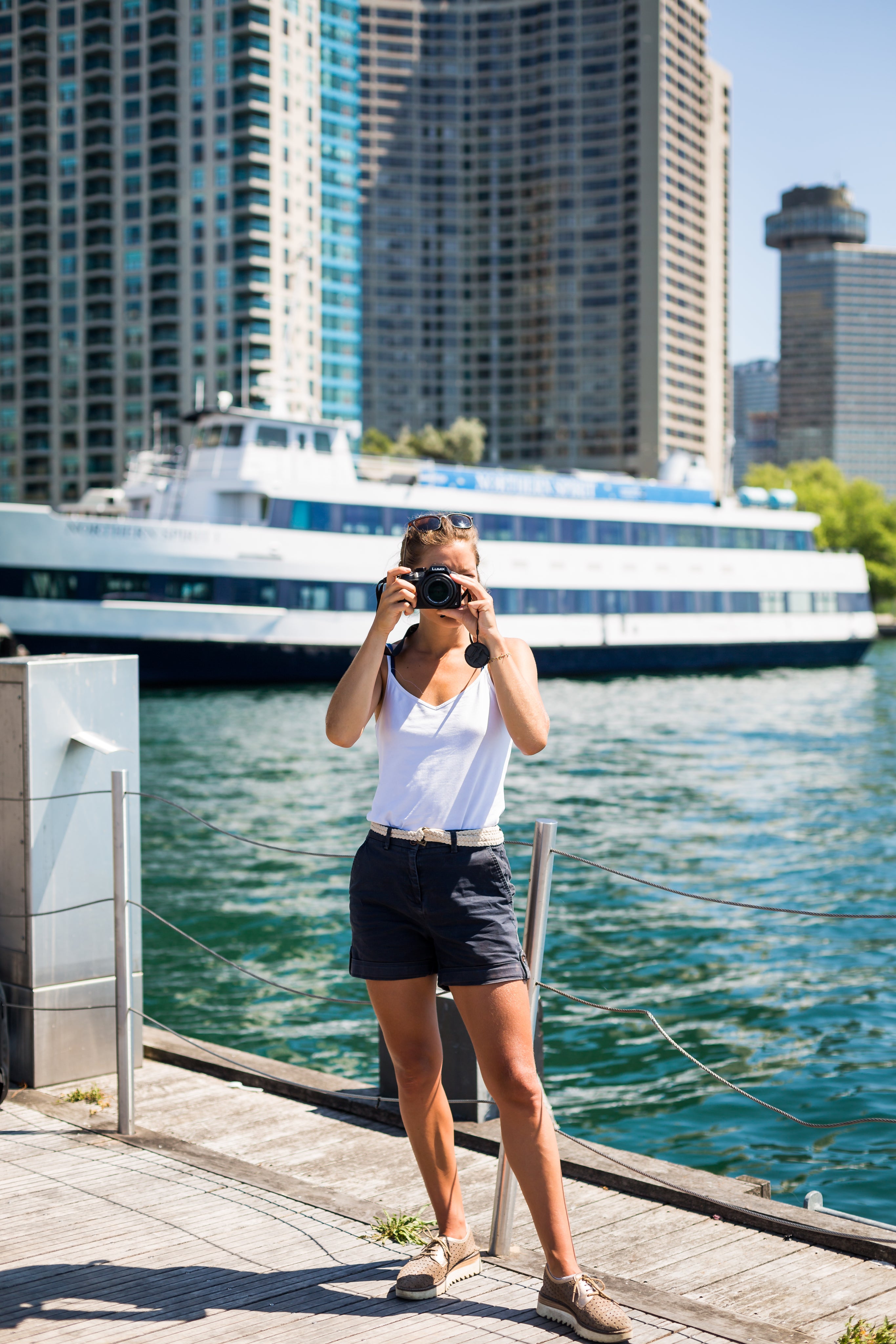 files/person-stands-by-waterfront-and-holds-camera-up-to-take-a-picture.jpg